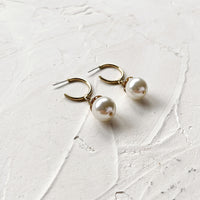 Thin gold hoop earrings with pearl